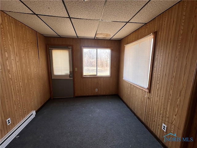 41 Dickens Dr, Toledo, OH 43607 - carpeted spare room with a baseboard radiator, wood walls, and a drop ceiling