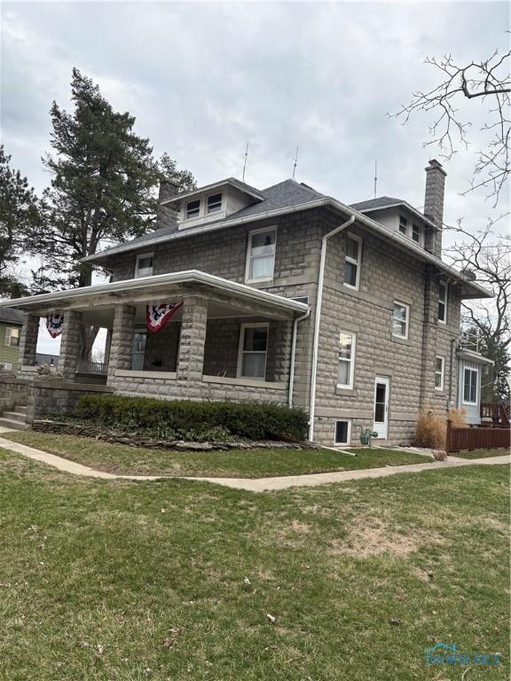 421 Farnsworth Rd, Waterville, OH 43566 - view of property exterior with a chimney, a lawn, a porch, and stone siding