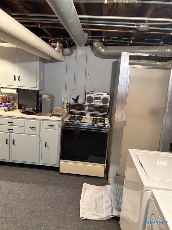 421 Farnsworth Rd, Waterville, OH 43566 - kitchen with range, washing machine and clothes dryer, white cabinetry, and light countertops