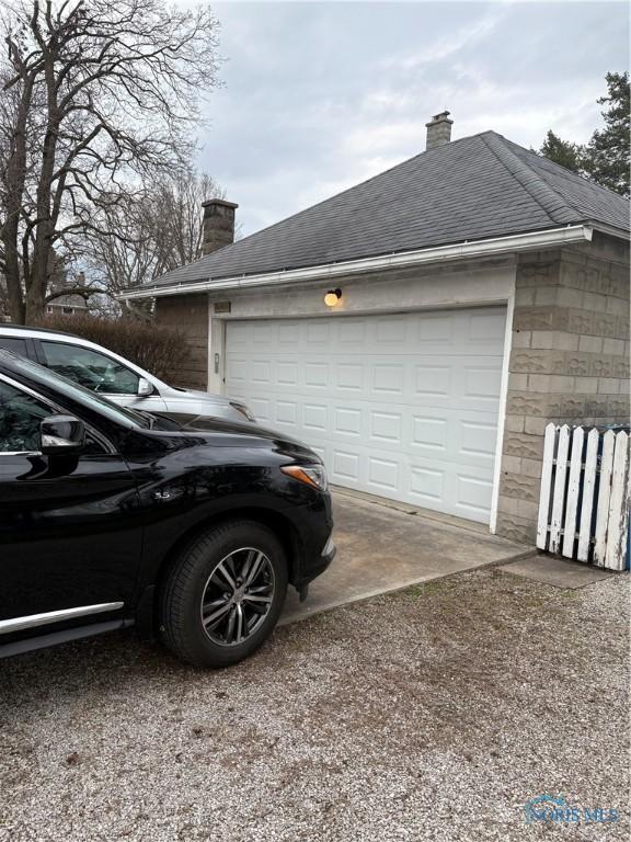 421 Farnsworth Rd, Waterville, OH 43566 - view of home's exterior featuring a chimney, driveway, a garage, and roof with shingles
