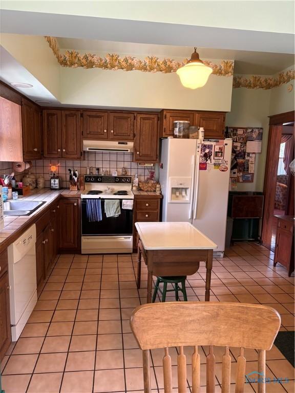 421 Farnsworth Rd, Waterville, OH 43566 - kitchen featuring white appliances, tile countertops, under cabinet range hood, and light tile patterned flooring