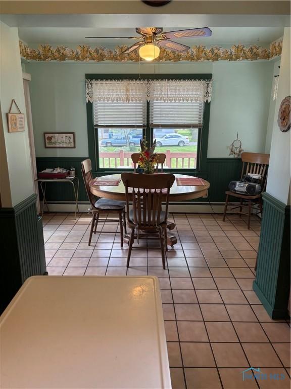 421 Farnsworth Rd, Waterville, OH 43566 - dining space featuring wainscoting, ceiling fan, light tile patterned flooring, and a baseboard radiator