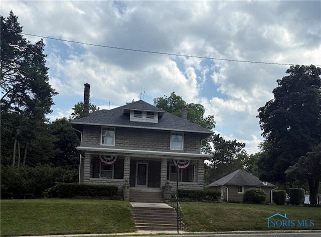421 Farnsworth Rd, Waterville, OH 43566 - american foursquare style home featuring a chimney, covered porch, a front yard, and stone siding