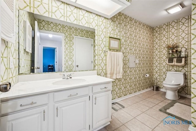 bathroom with wallpapered walls, toilet, and tile patterned flooring