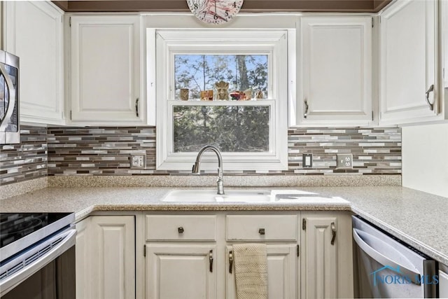 kitchen with light countertops, appliances with stainless steel finishes, and white cabinets