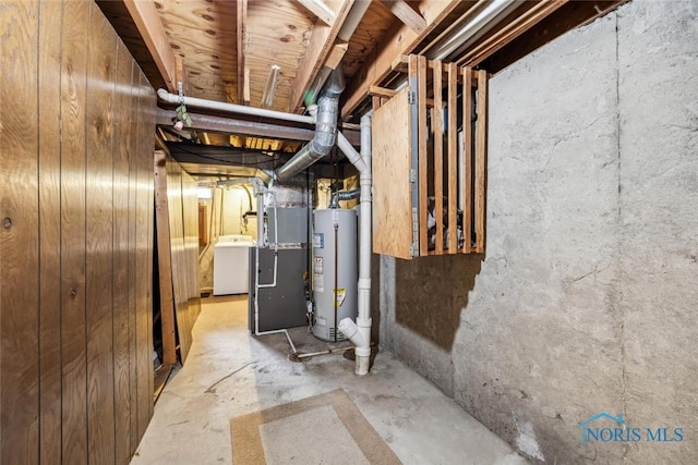 unfinished below grade area featuring washer / dryer and gas water heater