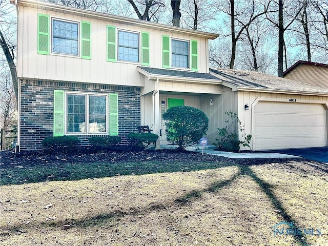 view of front of home featuring aphalt driveway, brick siding, and a garage