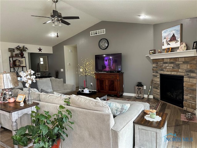 9277 Colonel Dr, Findlay, OH 45840 - living room with a fireplace, wood finished floors, lofted ceiling, visible vents, and ceiling fan