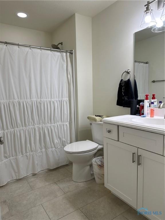 9277 Colonel Dr, Findlay, OH 45840 - full bathroom with toilet, vanity, a shower with shower curtain, and tile patterned flooring