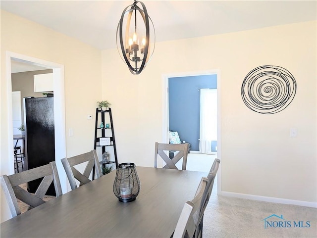 400 W St, Archbold, OH 43502 - dining area featuring light carpet, baseboards, and an inviting chandelier