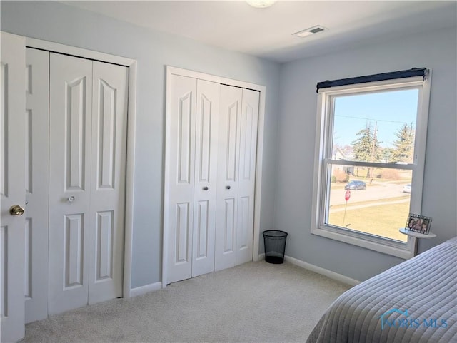 400 W St, Archbold, OH 43502 - carpeted bedroom with two closets, baseboards, and visible vents