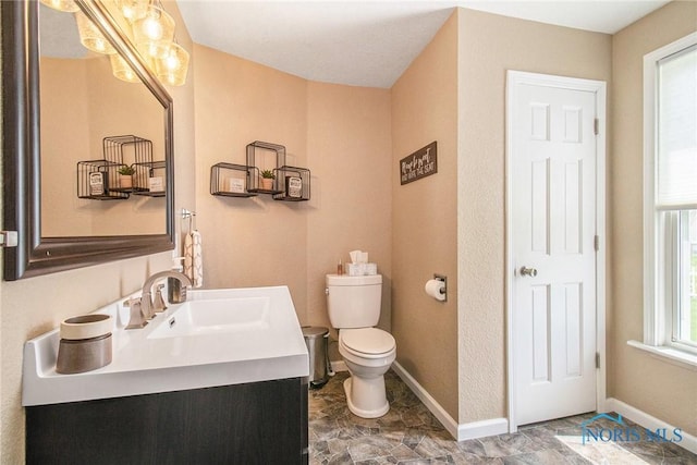400 W St, Archbold, OH 43502 - bathroom with baseboards, vanity, and toilet