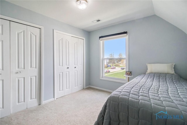 400 W St, Archbold, OH 43502 - carpeted bedroom with two closets, baseboards, lofted ceiling, and visible vents