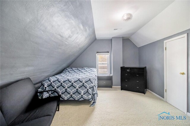 400 W St, Archbold, OH 43502 - bedroom featuring vaulted ceiling, carpet flooring, and baseboards