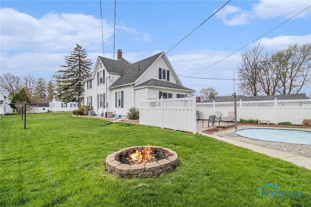 400 W St, Archbold, OH 43502 - view of yard featuring a fire pit, fence, a patio, and a fenced in pool