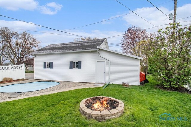 400 W St, Archbold, OH 43502 - rear view of property with a fire pit, a covered pool, fence, and a lawn