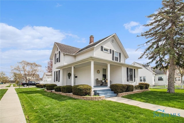 400 W St, Archbold, OH 43502 - farmhouse inspired home with fence, a front lawn, a chimney, and covered porch
