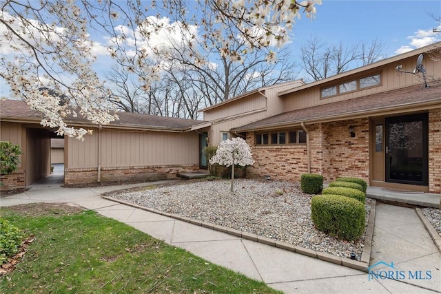 exterior space with brick siding