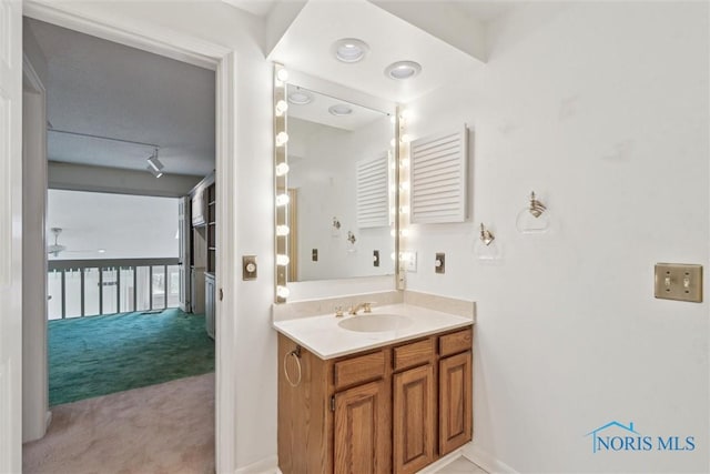 bathroom featuring a ceiling fan and vanity