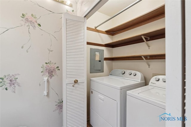 clothes washing area with washer and dryer, laundry area, and electric panel