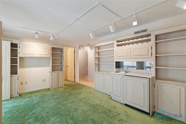 kitchen with open shelves, track lighting, visible vents, and light colored carpet