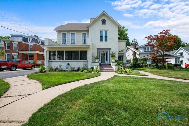 634 Holgate Ave, Defiance, OH 43512 - view of front of home with a front lawn and a sunroom