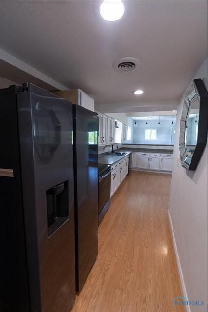 3844 Washburn Rd, Berkey, OH 43504 - kitchen with fridge with ice dispenser, a sink, light wood-type flooring, and white cabinets