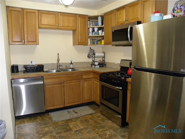117 Marshall Dr, Swanton, OH 43558 - kitchen with light countertops, brown cabinets, stainless steel appliances, a sink, and open shelves