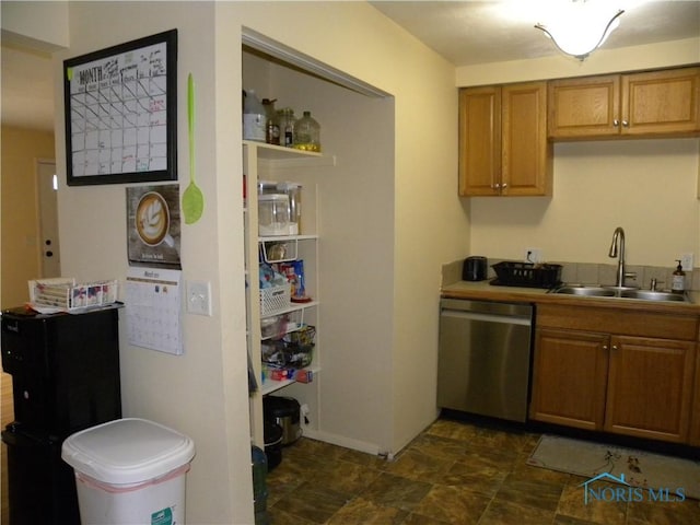 117 Marshall Dr, Swanton, OH 43558 - kitchen with stainless steel dishwasher, brown cabinetry, and a sink