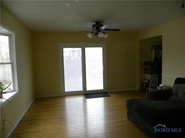 117 Marshall Dr, Swanton, OH 43558 - unfurnished living room featuring baseboards, ceiling fan, and wood finished floors