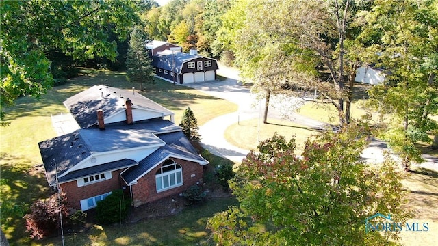 drone / aerial view with a wooded view