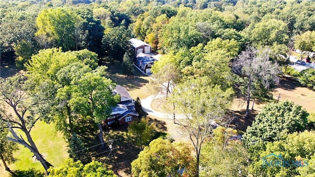 drone / aerial view featuring a wooded view