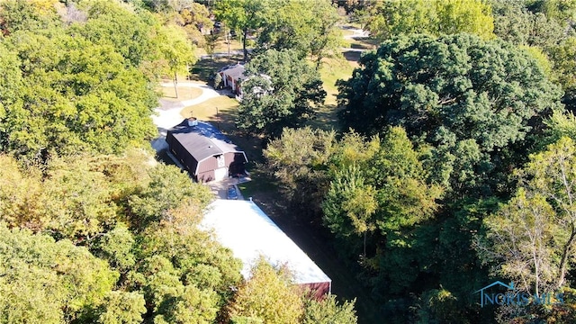 birds eye view of property with a view of trees