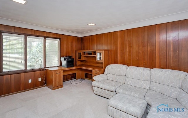 office space with light carpet and wooden walls