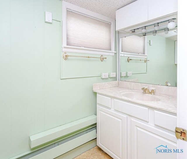 bathroom featuring a textured ceiling, tile patterned floors, and vanity