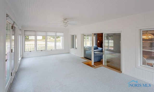 unfurnished sunroom with carpet