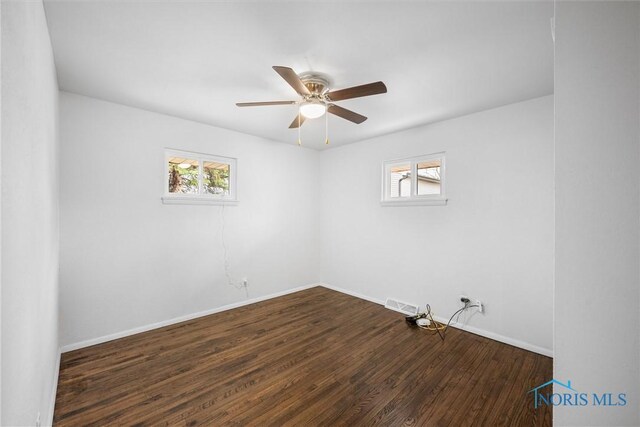 216 Licking St, Toledo, OH 43605 - unfurnished room featuring plenty of natural light, ceiling fan, wood finished floors, and baseboards