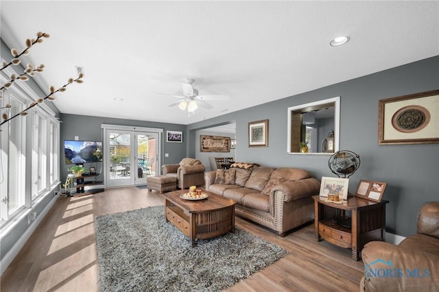 living area featuring recessed lighting, a ceiling fan, and wood finished floors