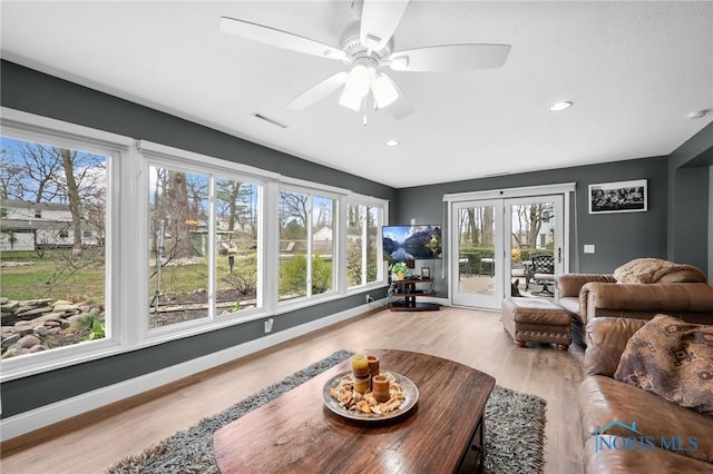 living area featuring visible vents, baseboards, a ceiling fan, recessed lighting, and wood finished floors