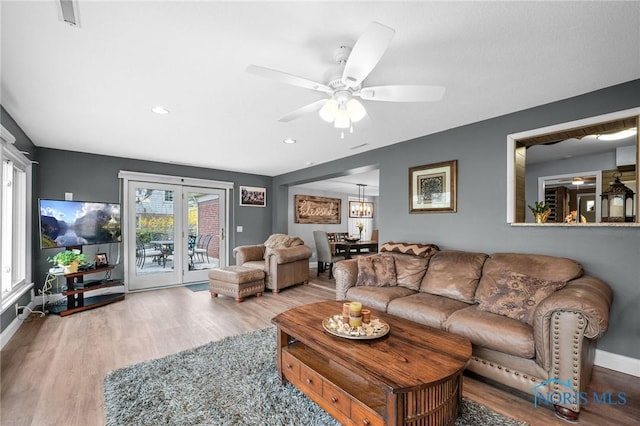 living room featuring visible vents, baseboards, a ceiling fan, recessed lighting, and wood finished floors