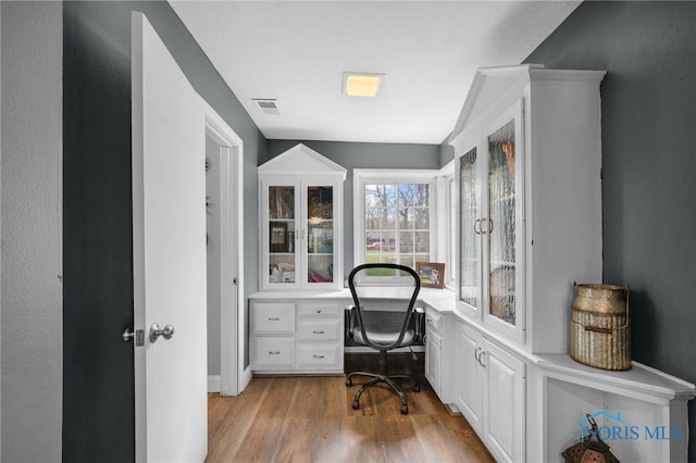 office featuring visible vents and wood finished floors