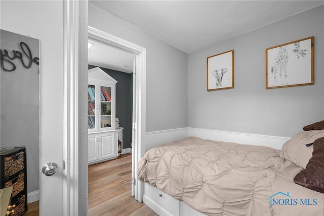 bedroom featuring wood finished floors