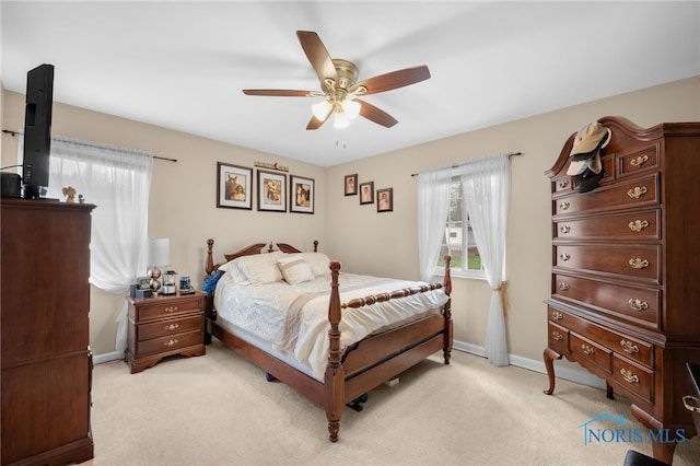 bedroom featuring baseboards, a ceiling fan, and light carpet
