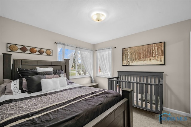 bedroom featuring carpet and baseboards