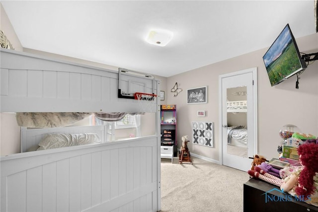 carpeted bedroom featuring baseboards