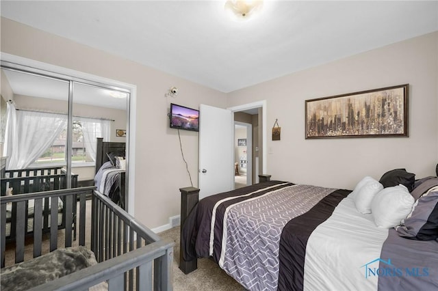 bedroom with carpet flooring and baseboards