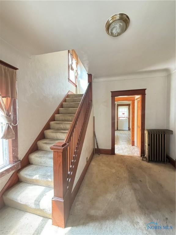 129 Everett St, Toledo, OH 43608 - staircase featuring carpet and radiator heating unit