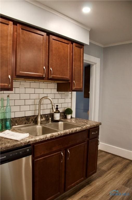 314 Caldwell St, Bradner, OH 43406 - kitchen featuring stainless steel dishwasher, a sink, baseboards, dark countertops, and crown molding