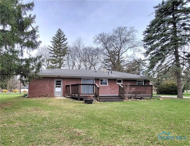 354 N River Rd, Waterville, OH 43566 - rear view of house with brick siding, a deck, and a lawn