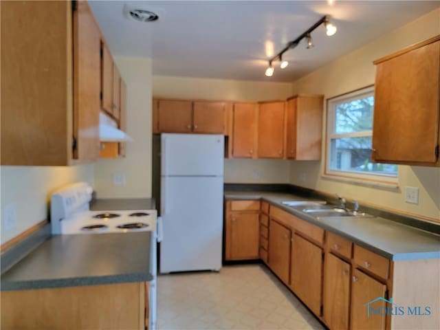 354 N River Rd, Waterville, OH 43566 - kitchen with white appliances, range hood, a sink, dark countertops, and light floors